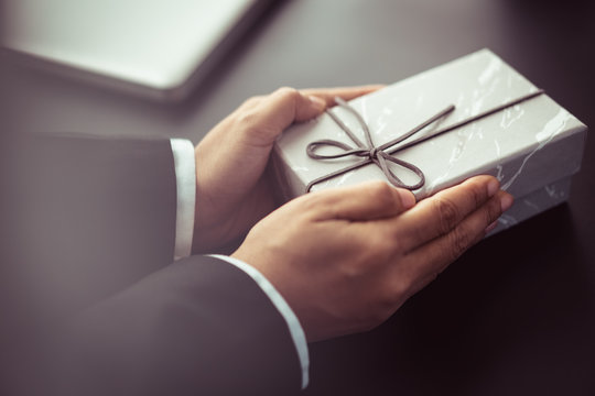 businessman with gift box on occasion of celebration