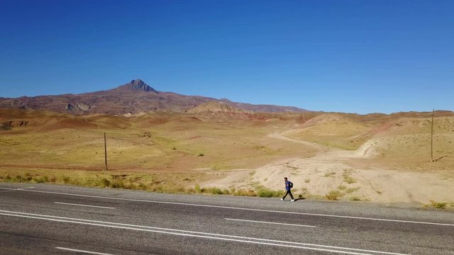 A man walking alone on the higway in Igdir, Turkey