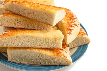 Cheese bread. Homemade delicious  soft cheese bread sticks close up on a plate on white background