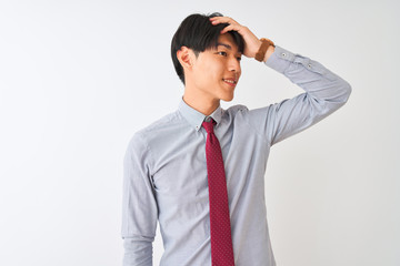Chinese businessman wearing elegant tie standing over isolated white background smiling confident touching hair with hand up gesture, posing attractive and fashionable