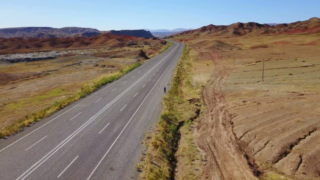 A man walking alone on the higway in Igdir, Turkey