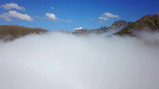 Drone flying cloud view, Peak top foggy mountains, blue sky