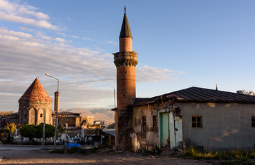Fototapeta na wymiar Morning view an old mosque and the 14th century Yakutia Medrese in the background in Erzurum, Turkey
