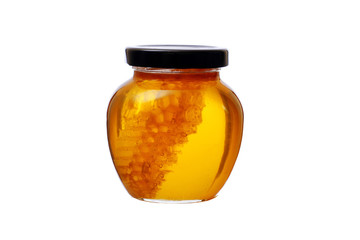 glass jar of honey with honeycomb inside isolated on white background