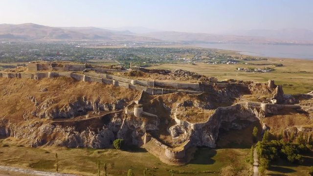 Historical Eastern fortress, Van Castle on rocky hill and mosques