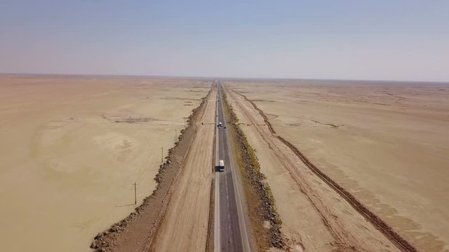 Dusty highway on the oriental yellow desert in Iran