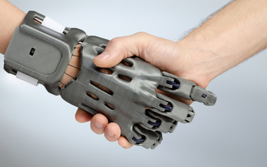 Hand with prosthesis printed on FDM 3D printer, handshake of the prosthesis and a healthy hand on...