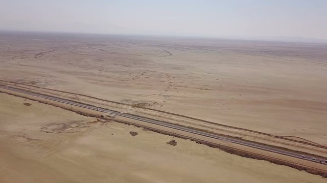 Dusty highway on the oriental yellow desert in Iran