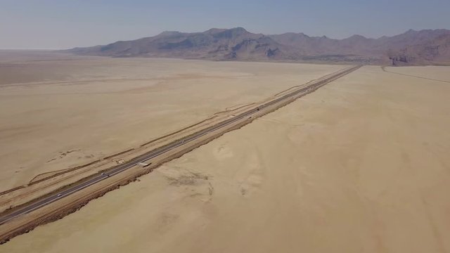 Dusty highway on the oriental yellow desert in Iran