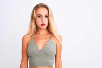Young beautiful woman wearing casual green t-shirt standing over isolated white background depressed and worry for distress, crying angry and afraid. Sad expression.