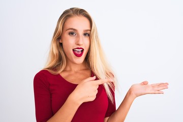 Young beautiful woman wearing red t-shirt standing over isolated white background very happy pointing with hand and finger