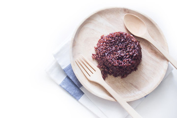 Cooked purple rice berry in wooden plate on white background , clean food, healthy eating.