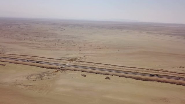 Dusty highway on the oriental yellow desert in Iran