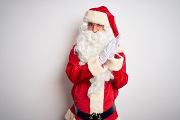 Middle age handsome man wearing Santa costume standing over isolated white background clapping and applauding happy and joyful, smiling proud hands together