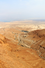 Judaean Desert panorama with wadis and salt lake dead sea seen from Masada fortress, Israel