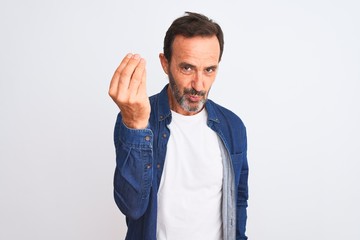 Middle age handsome man wearing blue denim shirt standing over isolated white background Doing Italian gesture with hand and fingers confident expression