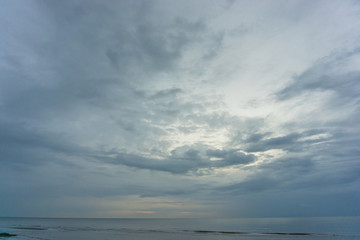 Fototapeta na wymiar dark cloudy sky and sea. there is light shine through the cloud.