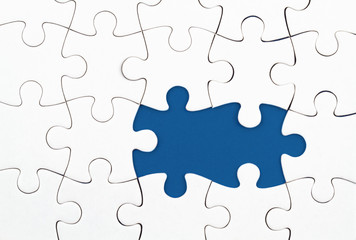 White puzzle over blue backround with missing pieces. Incomplete elements, solution search concept