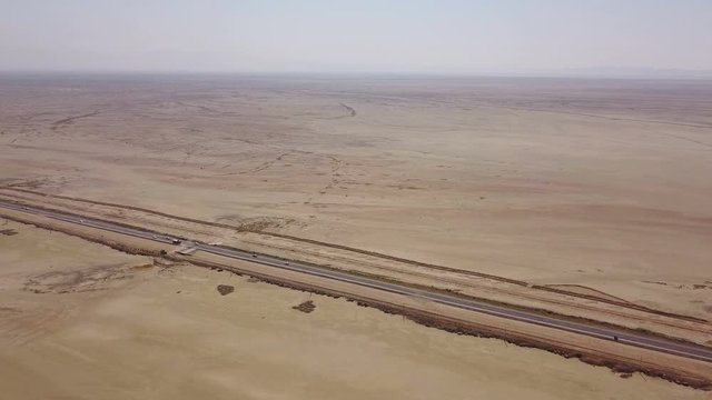 Dusty highway on the oriental yellow desert in Iran
