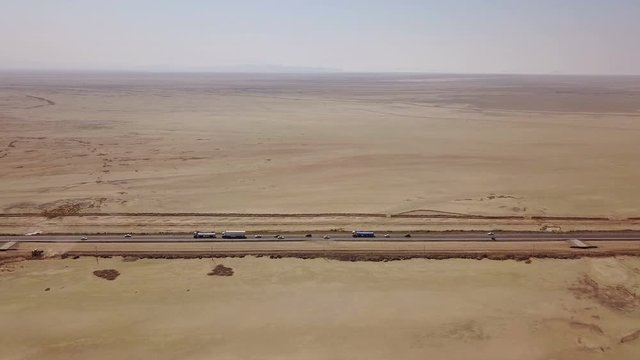 Dusty highway on the oriental yellow desert in Iran