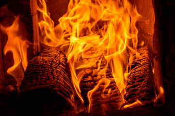 Fire burns close-up in the stove. Firewood is burning.