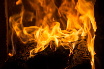 Fire burns close-up in the stove. Firewood is burning.