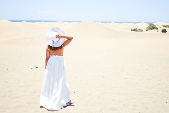 Young beautiful woman smiling happy enjoying summer vacation at maspalomas dunes beach