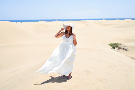 Young beautiful woman smiling happy enjoying summer vacation at maspalomas dunes beach