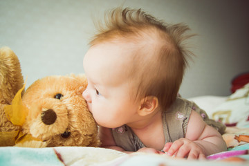 Baby plays with a teddy bear