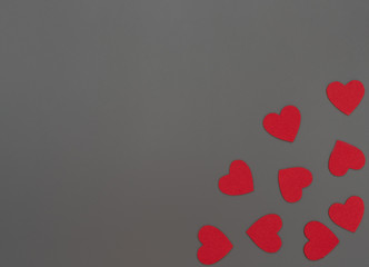 A lot of red hearts on grey background. Valentine's Day concept. Valentine greeting card. Flat lay style with copy space.