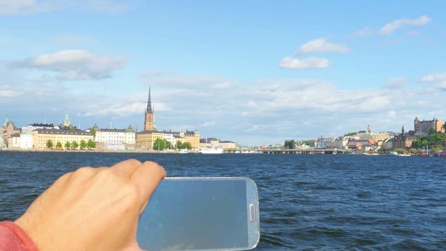 tourist taking picture in sightseeing tour, stockholm, sweden