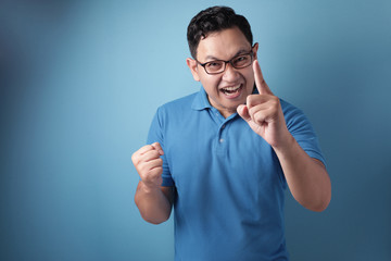 Happy optimistic man shows number one finger sign gesture