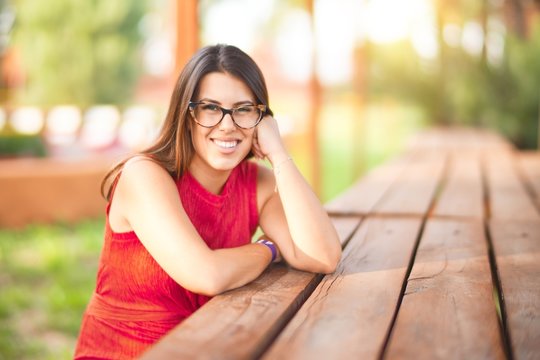 Young beautiful girl smiling happy and confident walking at the town park, standing with a smile on face