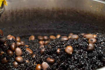 The process of roasting chestnuts with hot stones