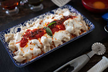 Turkish ravioli mantı preparation with meat, yogurt, butter and dough