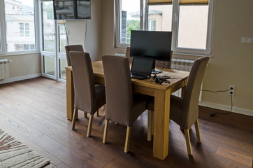 Part of a newly renovated living room with TV, table, chairs, laptop computer, mobile telephone and headset, Sofia, Bulgaria, Europe 