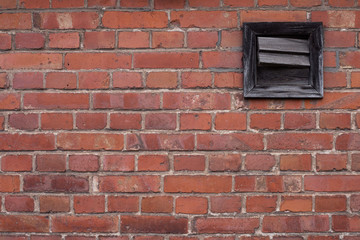 Fototapeta na wymiar old red brick wall with a window