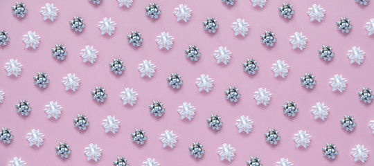 Christmas background with decorations and gift boxes on pink background