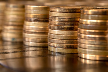 Piles of coins on the table. Coins side view. Coins macro shot.