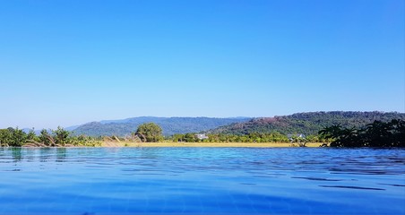 The pool with mountain range and clear blue sky background with above copy space. Beautiful of Nature and Natural wallpaper