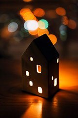 Candlestick house on dark blurred background.