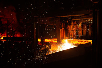 Hot red steel billets at torch cutting. Background of the blacksmith and metallurgical industry.