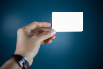 Hand holding  a blank piece of paper. Close up  white business card.