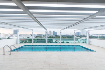 swimming pool and cityscape view at top of tower .