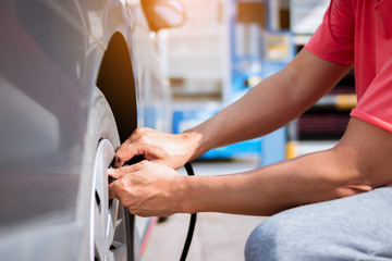 Close up hand of man inflating tire.