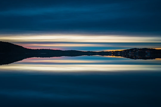 Hills at sunset reflecting in lake