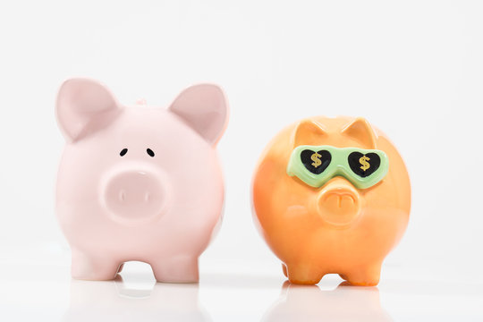 Concept image image for saving featuring two piggy banks one of which appears to be more successful. 