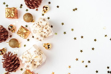 Christmas composition. Christmas golden decor, pine cone, star on white background. Flat lay, top view, copy space
