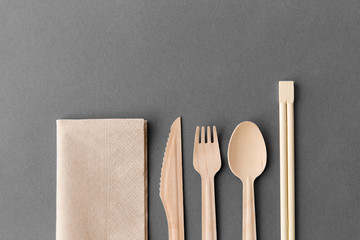 cutlery, recycling and eco friendly concept - wooden disposable spoon, fork, knife with chopsticks...