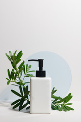 Bottles of shampoo and tropical leaf on color background. Beauty concept - obrazy, fototapety, plakaty